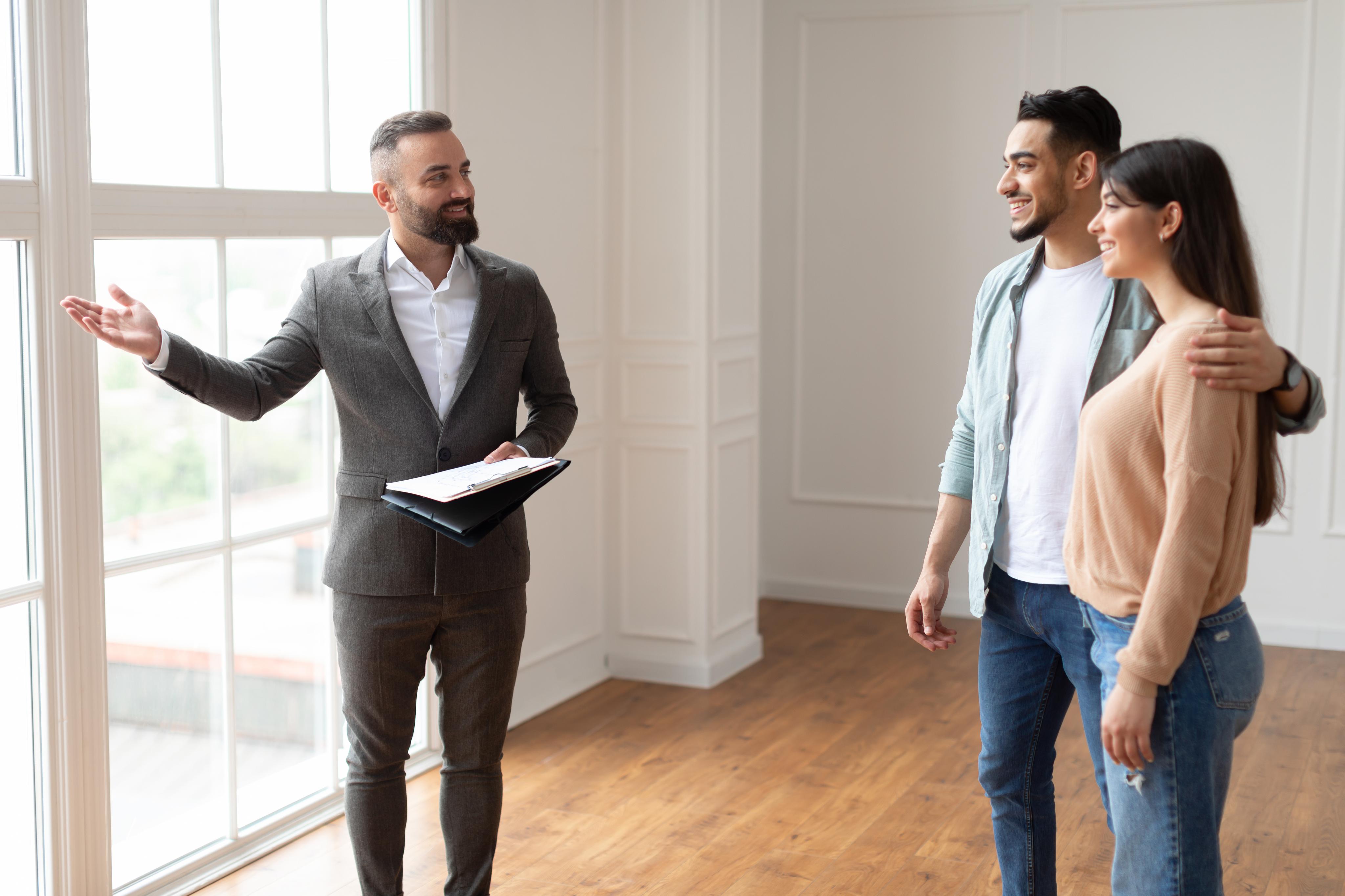 estate agent showing property for young buyers