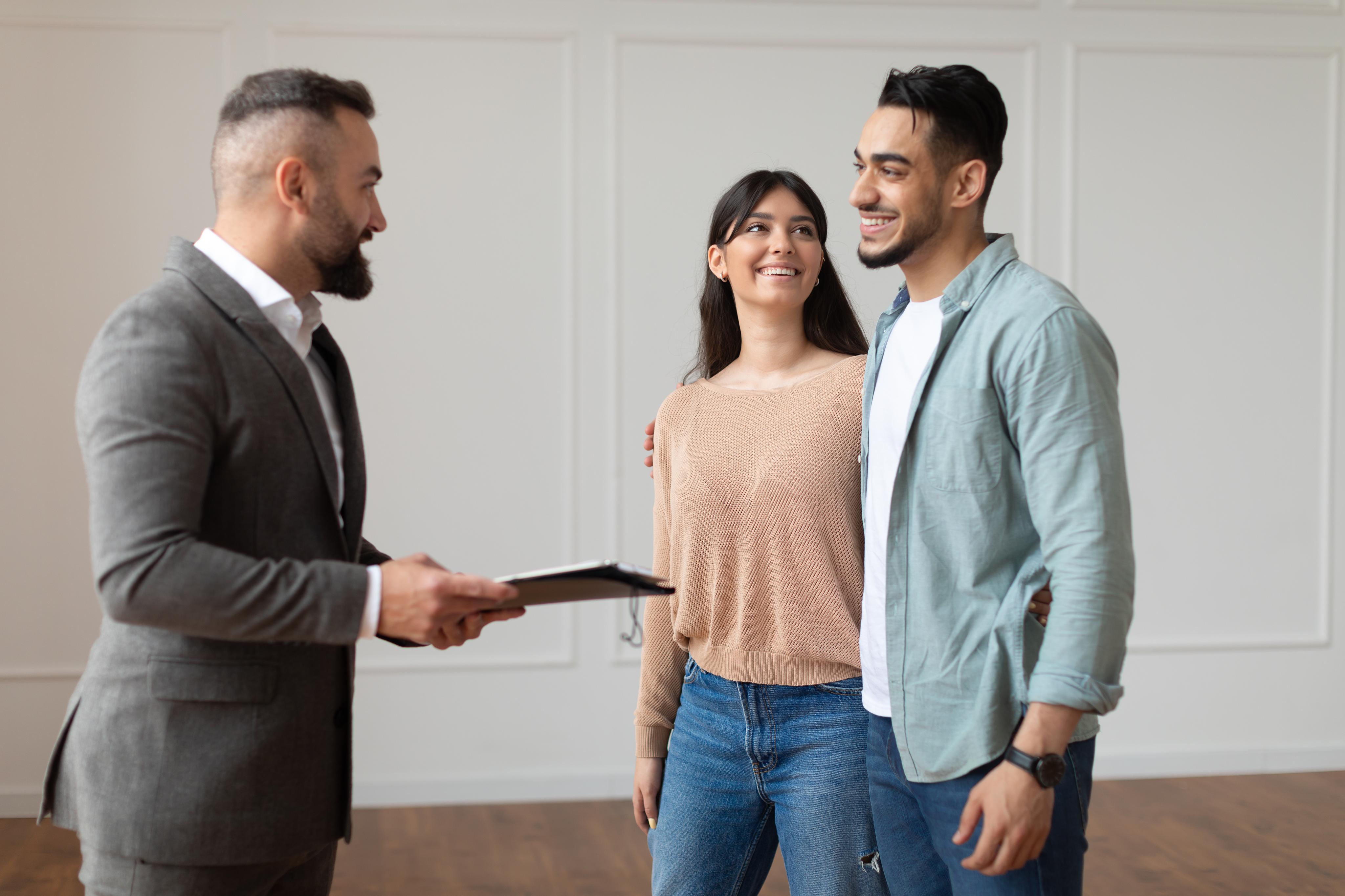 estate agent showing property for young buyers