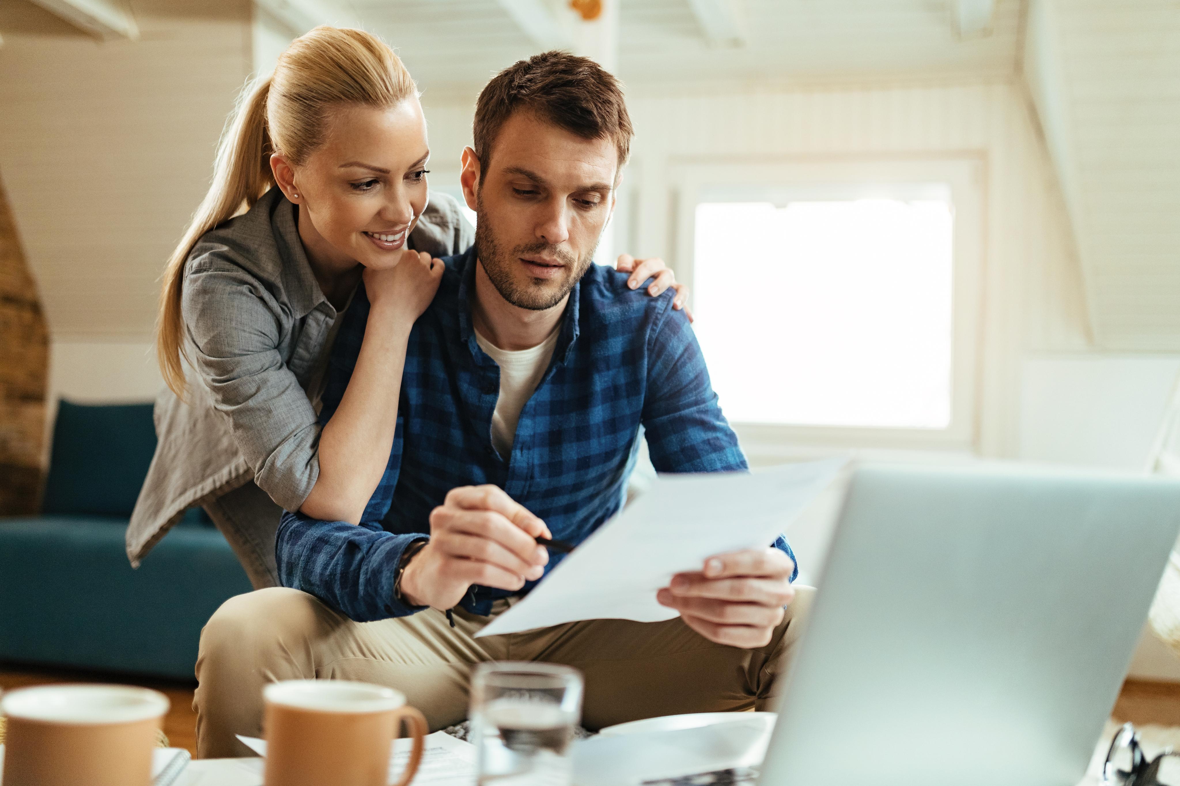 smiling woman and her husband going through their apartment